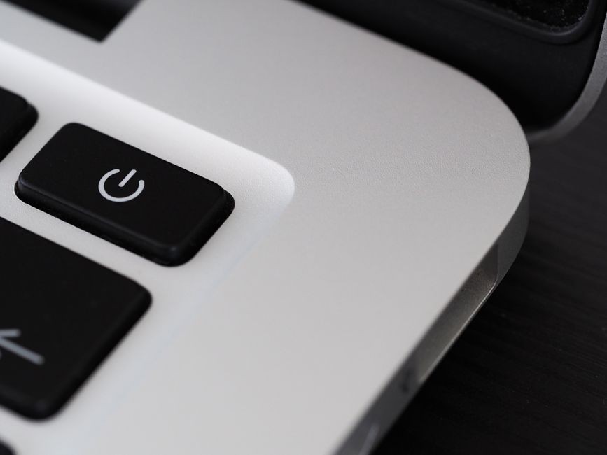Adaptor pengisi daya tercolok ke stopkontak rumah untuk mengisi laptop dan ponsel