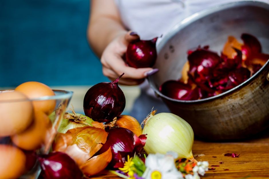 Sisa sayur, kulit buah, dan ampas kopi yang dipisahkan di atas meja dapur sebagai bahan baku kompos