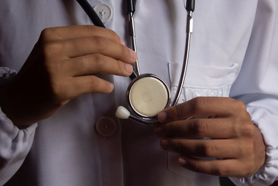 Dokter memeriksa pasien dengan stetoskop untuk evaluasi fungsi paru-paru.