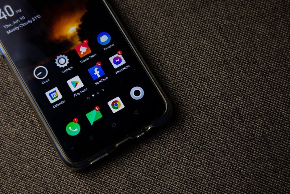 Tangan mengetuk menu pengaturan di layar ponsel Android